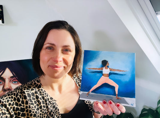 Louise Thompson holding yoga painting